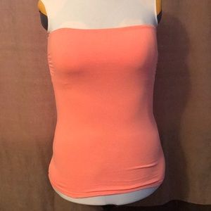 Coral colored strapless top, great for layering.